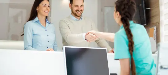 Dental Office Receptionist Greeting New Patients at Front Desk