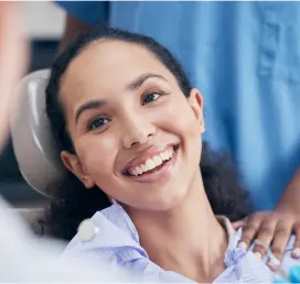 Woman Smiling On A Dental Chair