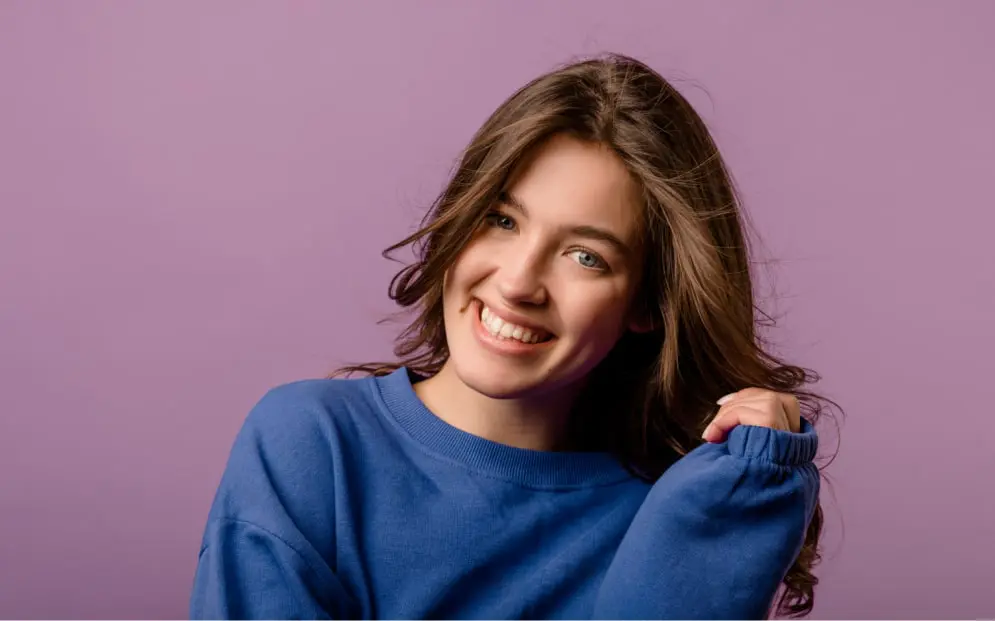 Woman Smiling Confidently After Tooth Crown Treatment In Richmond, MI