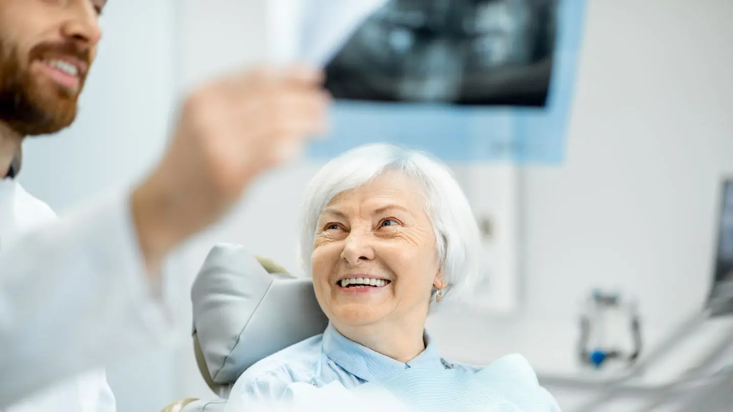 Dentist Showing Dental X-ray to an Elderly Patient