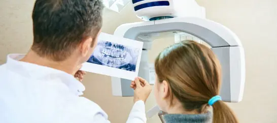 Dentist Showing Patient Dental X-ray