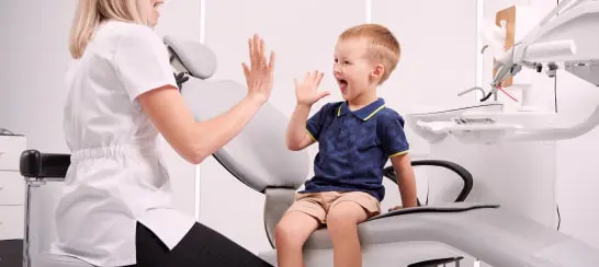 A Child and A Dentist In A Dental Clinic